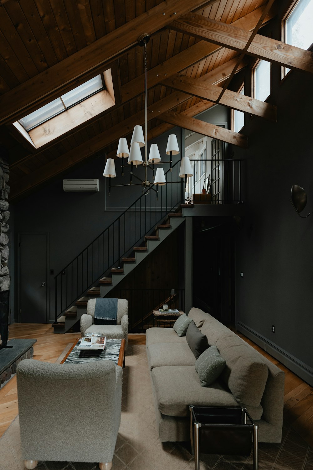 a living room filled with furniture and a staircase