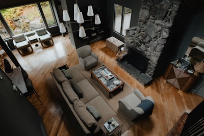 A cozy living room set with a sofa and armchairs in warm tones.