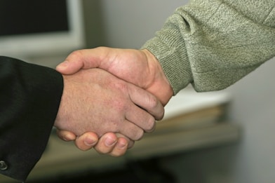a close up of two people shaking hands