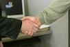 A successful recruitment process handshake between recruiter and candidate.