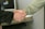 Close-up of a handshake between two professionals in an office setting.