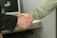 A professional shaking hands with a cybersecurity expert in a modern office setting.
