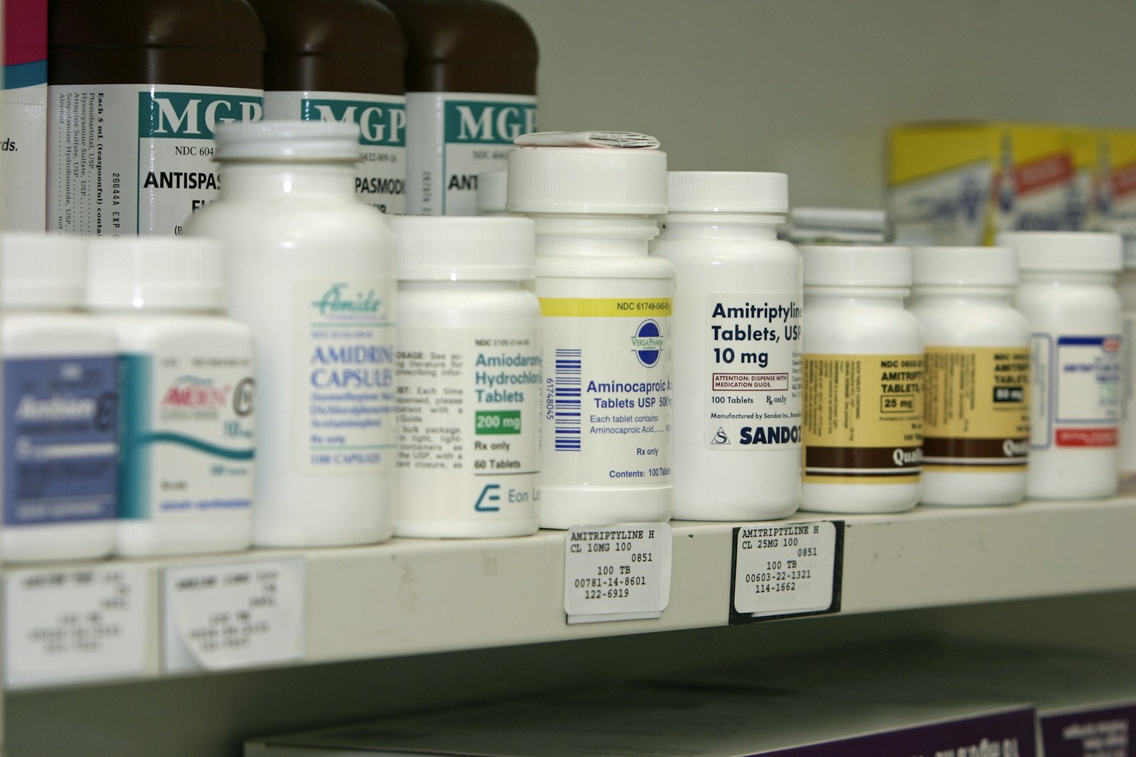 A pharmacy shelf lined with medicine bottles, representing the regulated retail channel unapproved research peptides never reach