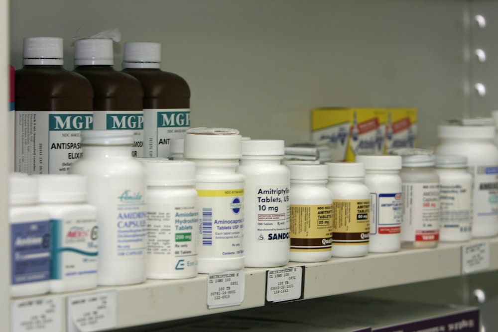 a shelf filled with lots of different types of medicine