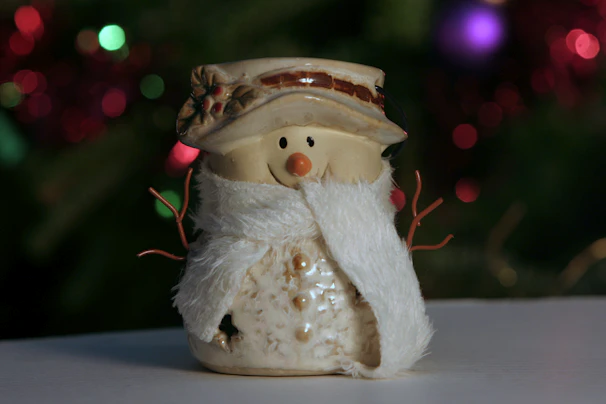 Close-up of a completed holiday-themed plaster mold shaped like a snowman, painted with cheerful colors.