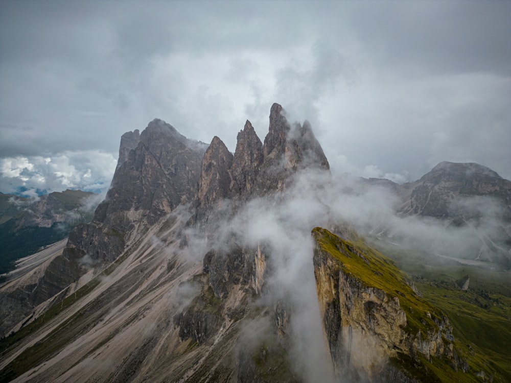 a mountain range covered in fog and clouds