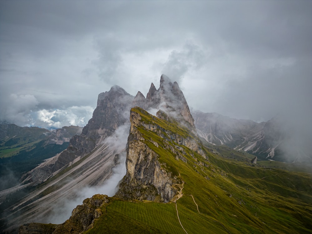 a very tall mountain covered in fog and clouds