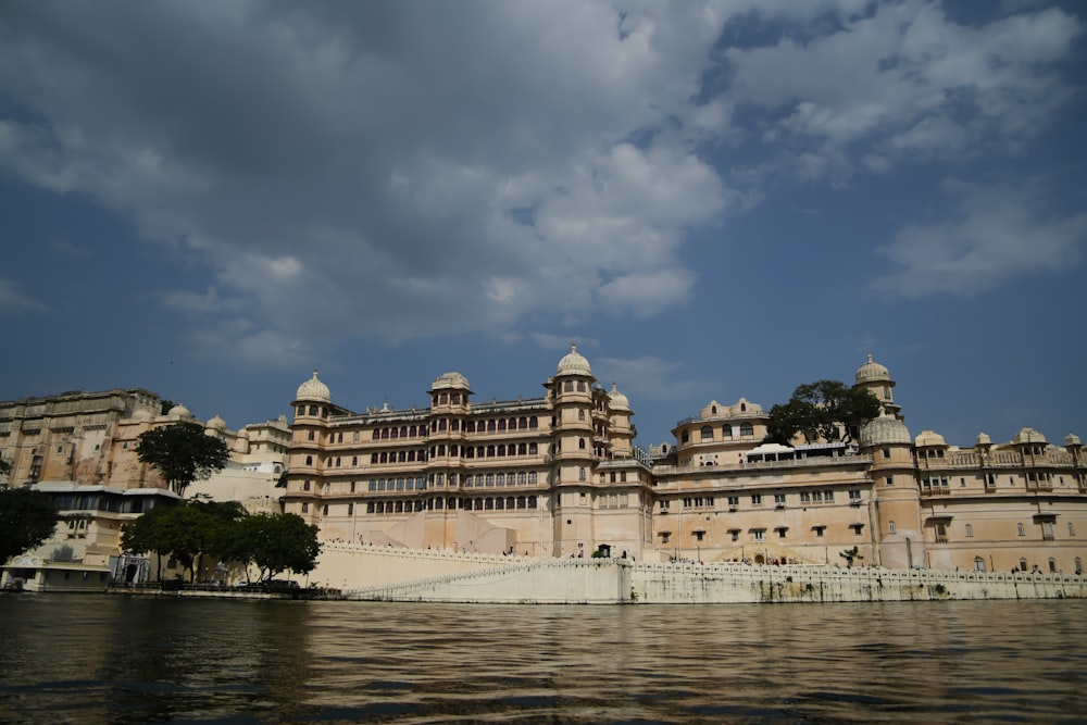 a large building sitting on the side of a body of water