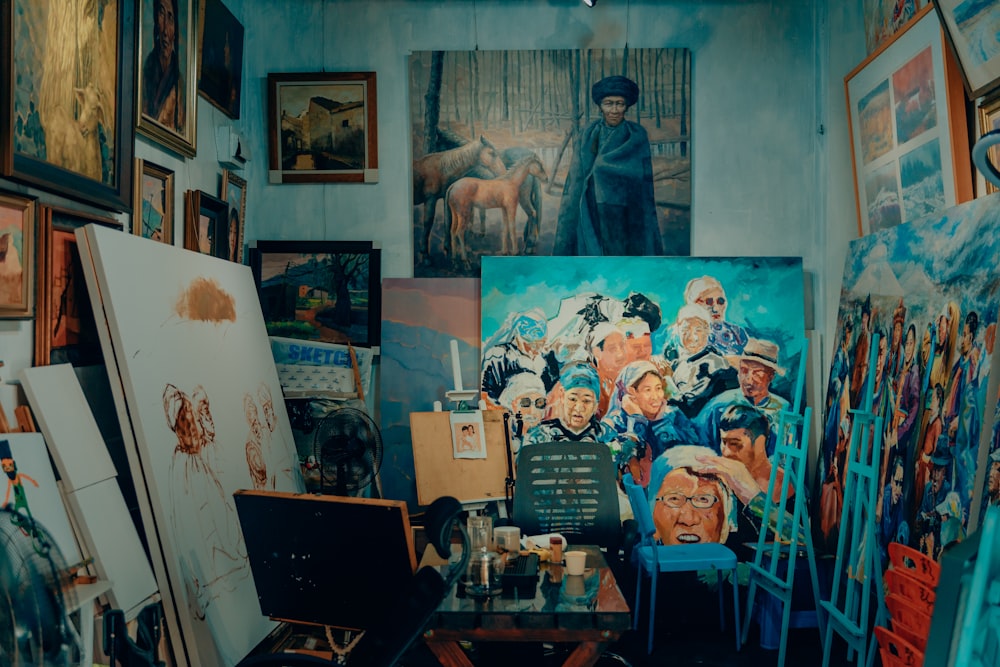 a room filled with lots of paintings and paintings