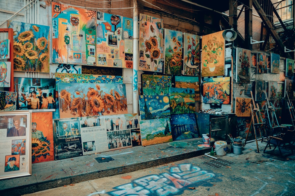 a bunch of paintings that are on a wall