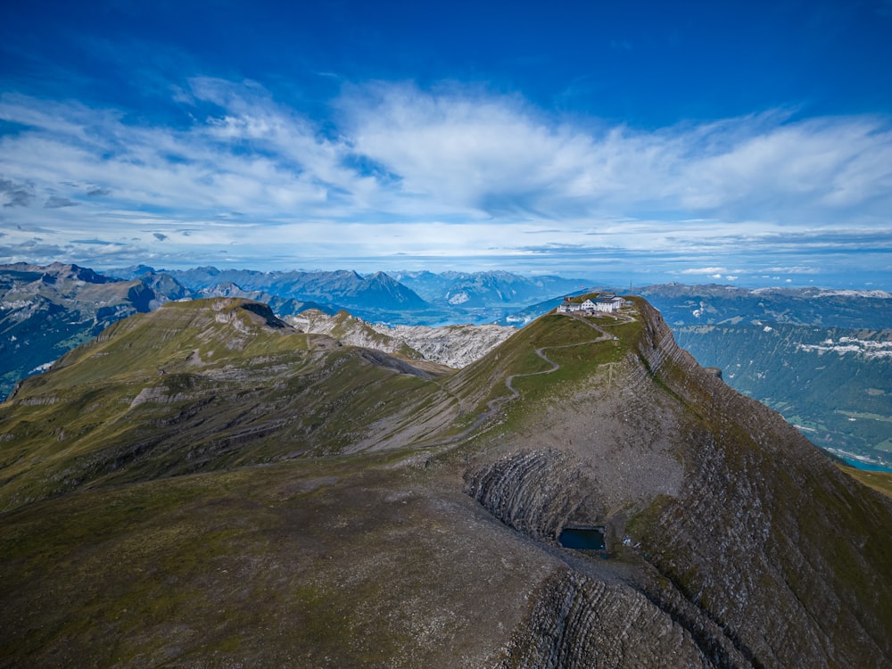 a scenic view of a mountain range with a blue sky in the background