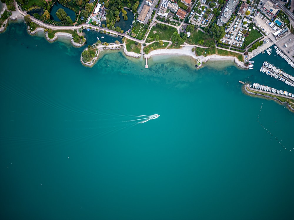 an aerial view of a boat in a body of water