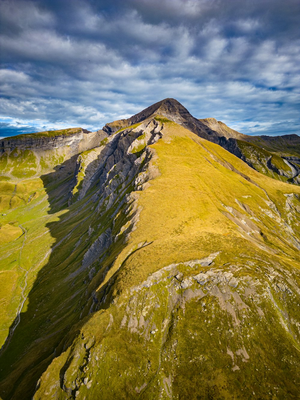 a mountain with a very tall green mountain in the background