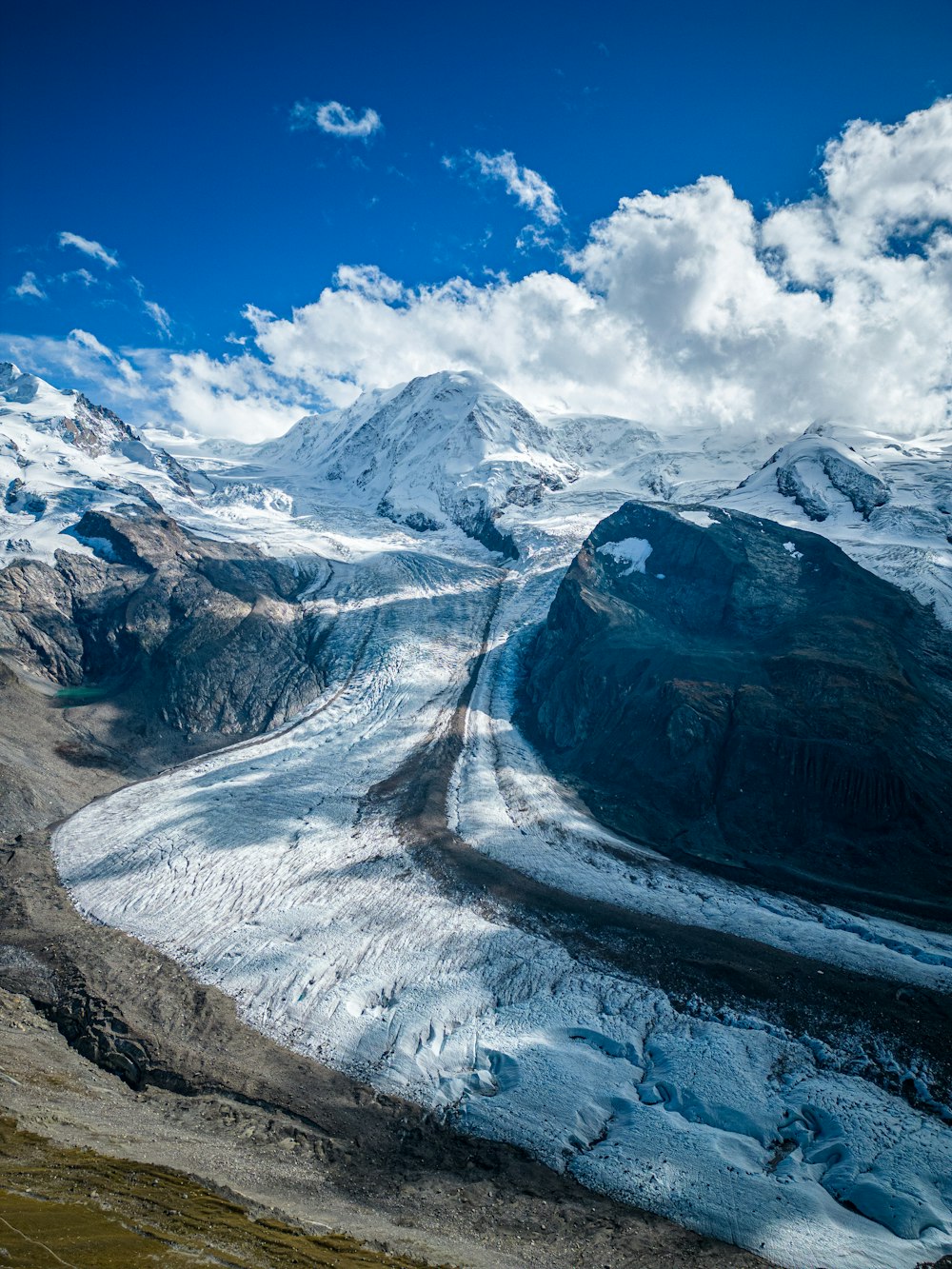 a view of a mountain range with snow on it