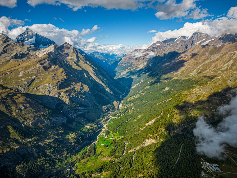 a scenic view of a valley surrounded by mountains