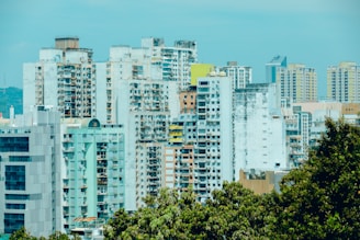 A cityscape featuring diverse residential buildings representing property developments.