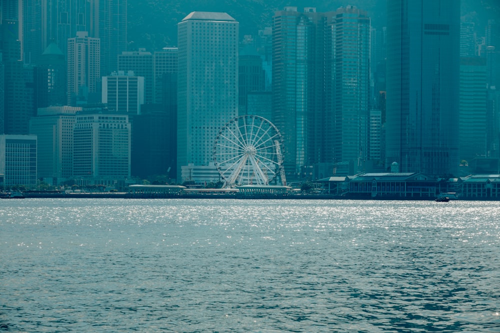 a large body of water with a ferris wheel in the background