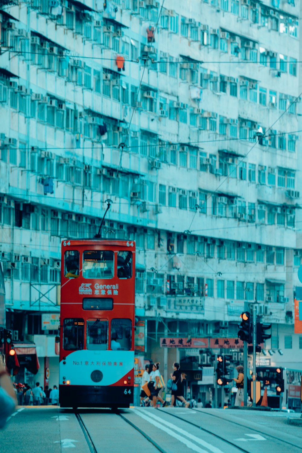 a red double decker bus driving down a street