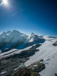 A stunning high-resolution photo of a towering ice mountain under a clear blue sky.
