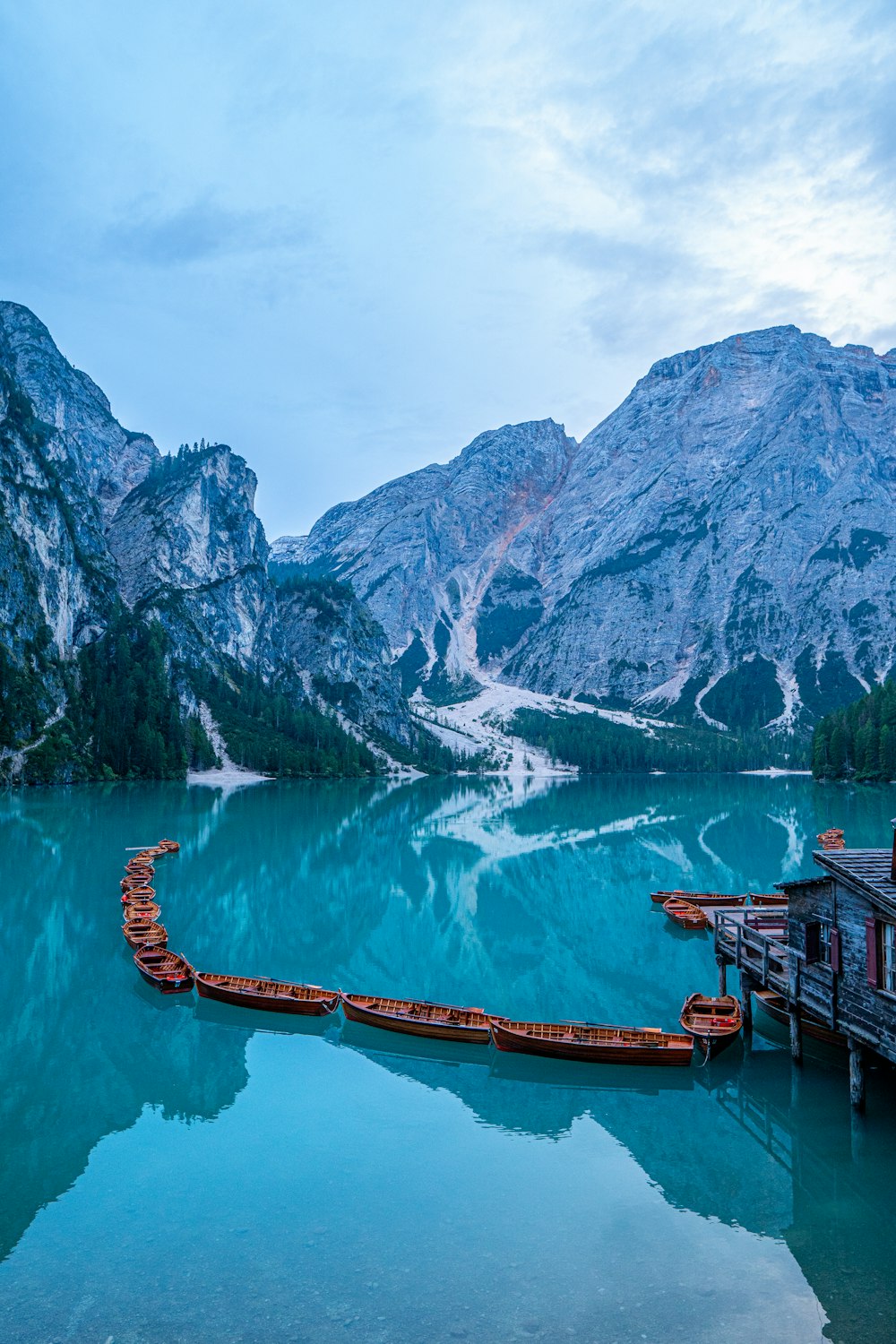 a long boat floating on top of a lake