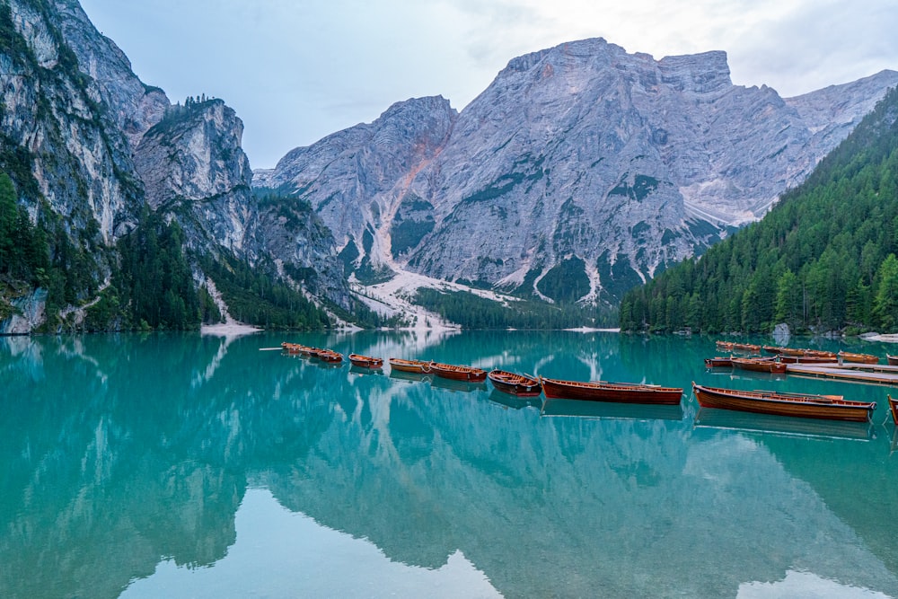 a group of boats floating on top of a lake