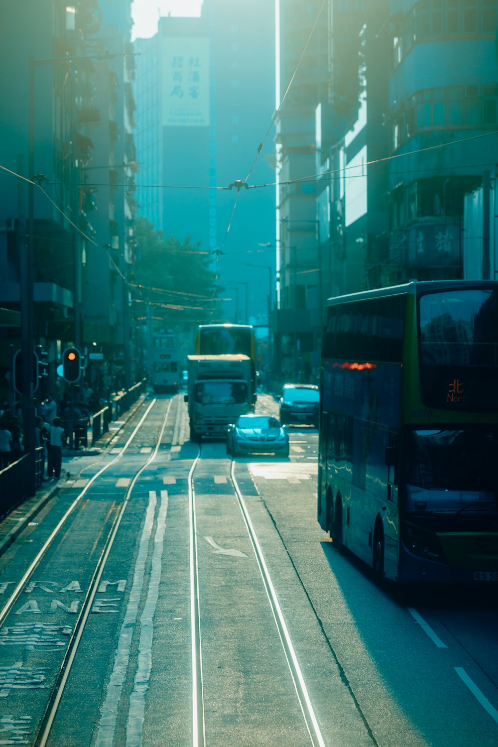 a city street filled with traffic next to tall buildings