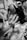 A person is having makeup applied to their face by another individual's hands. The setting appears to be indoors with a slightly blurred background, possibly indicating a busy or crowded environment.