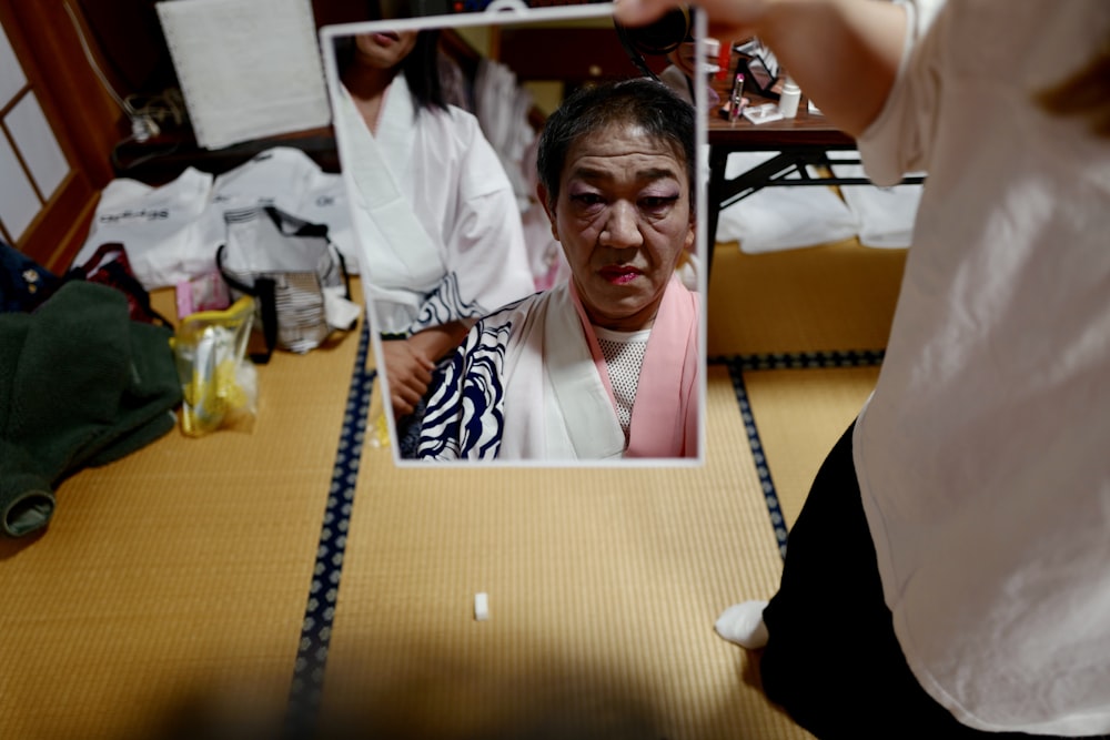 a woman is looking at her reflection in a mirror