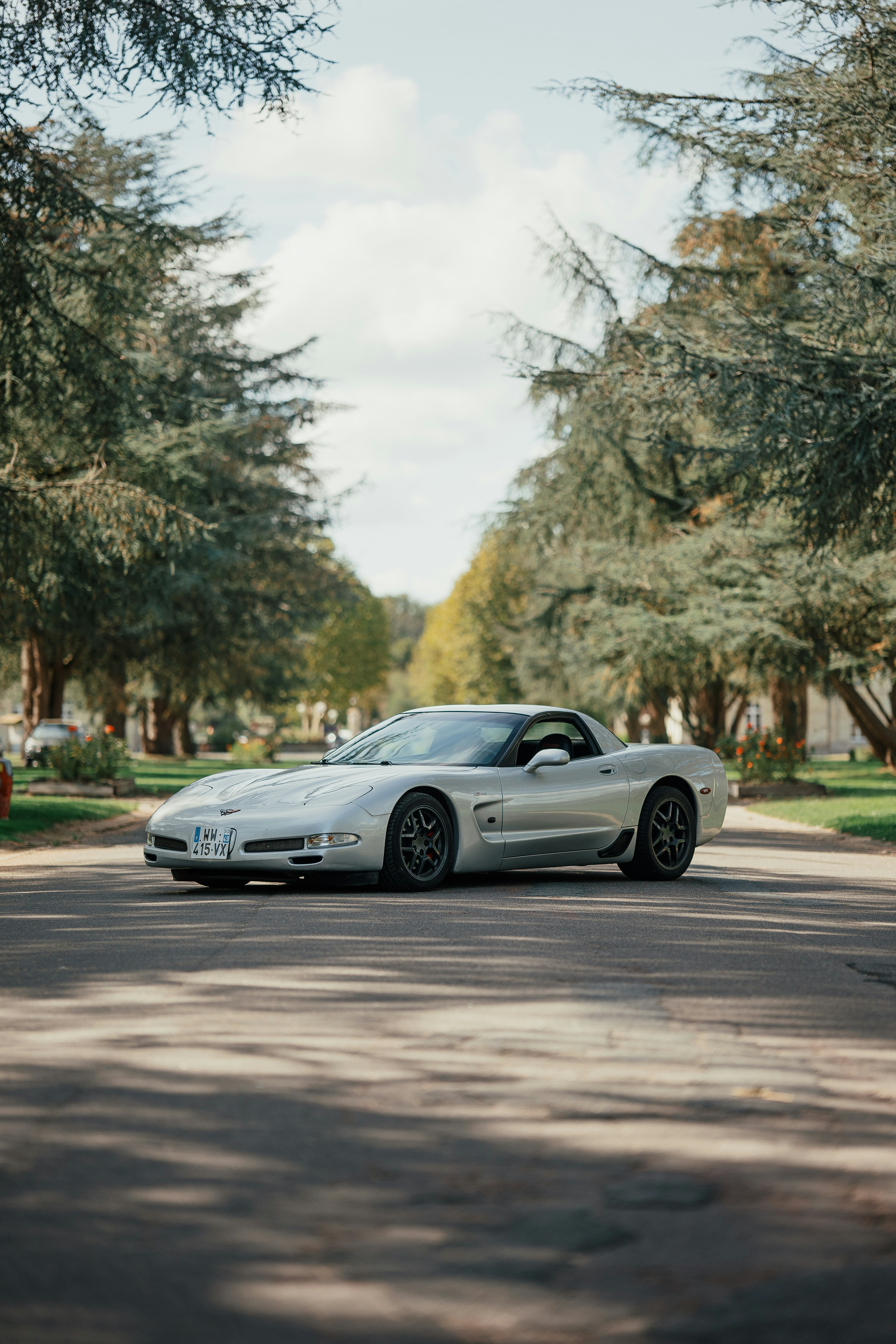 a silver sports car parked on the side of the road