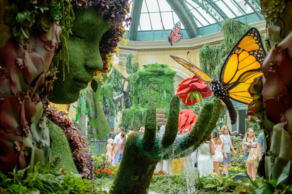 a statue of a woman with a butterfly on her head