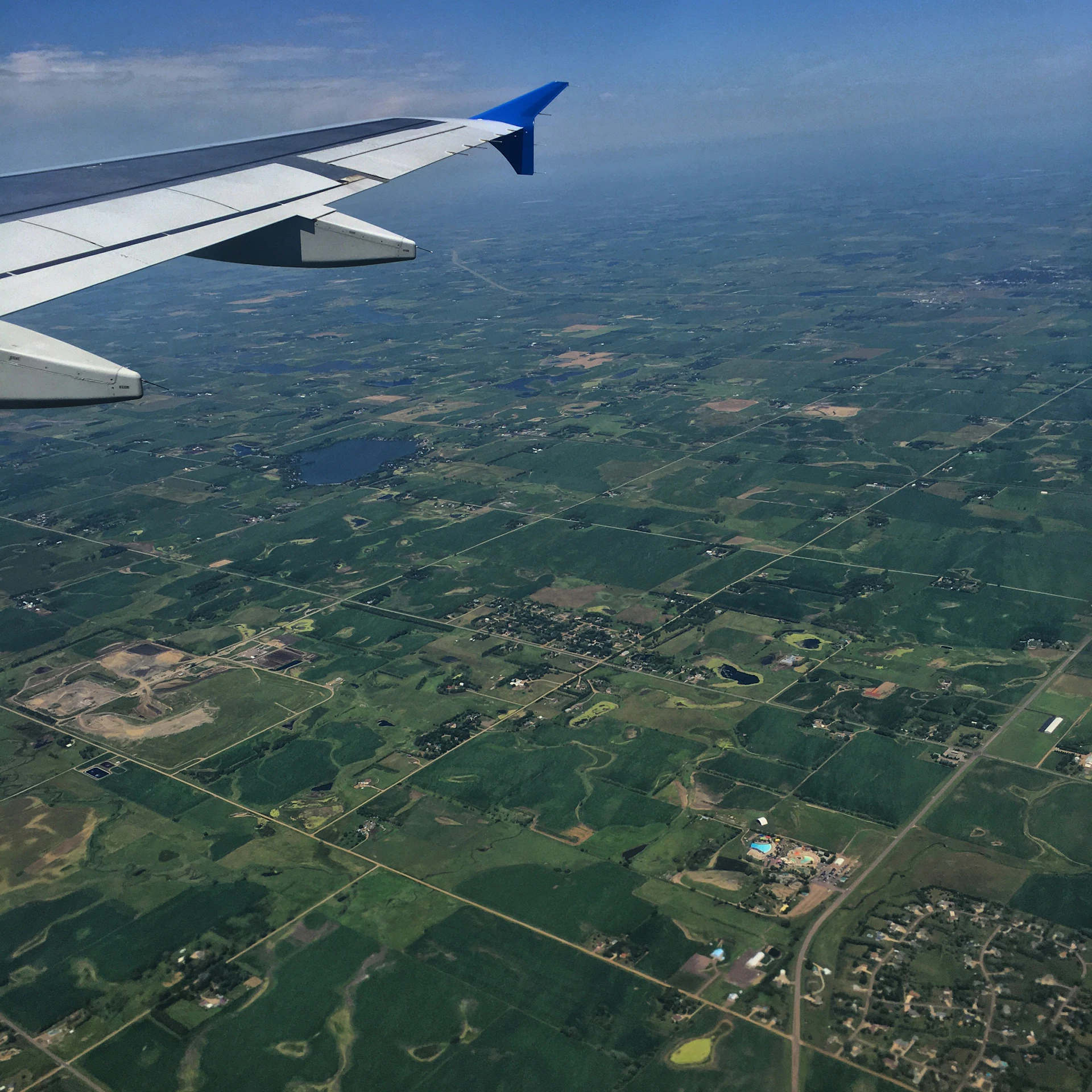 woman wearing yellow long-sleeved dress under white clouds and blue sky during daytime
