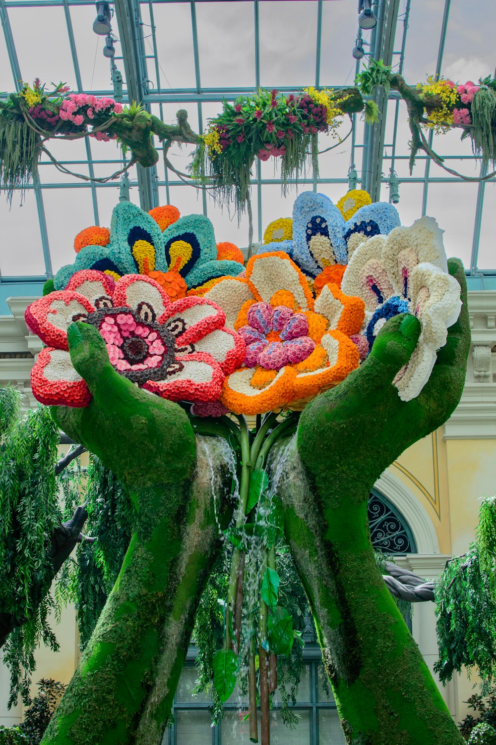 a sculpture of hands holding a bouquet of flowers