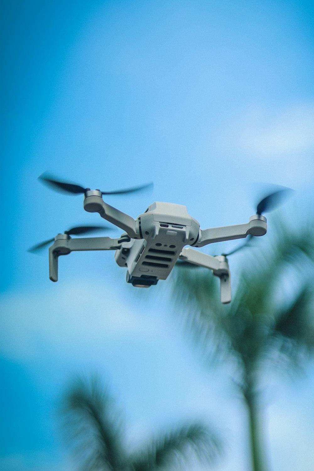 a close up of a white remote control flying in the sky