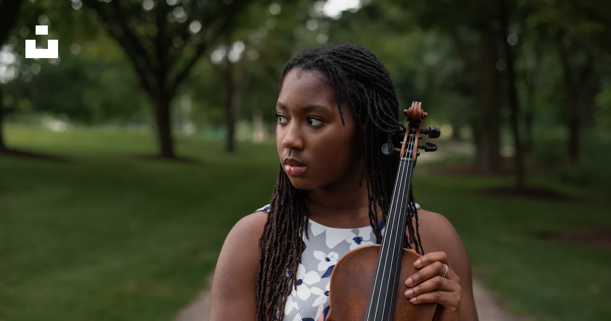 A woman with dreadlocks holding a violin photo – Free Musical ...