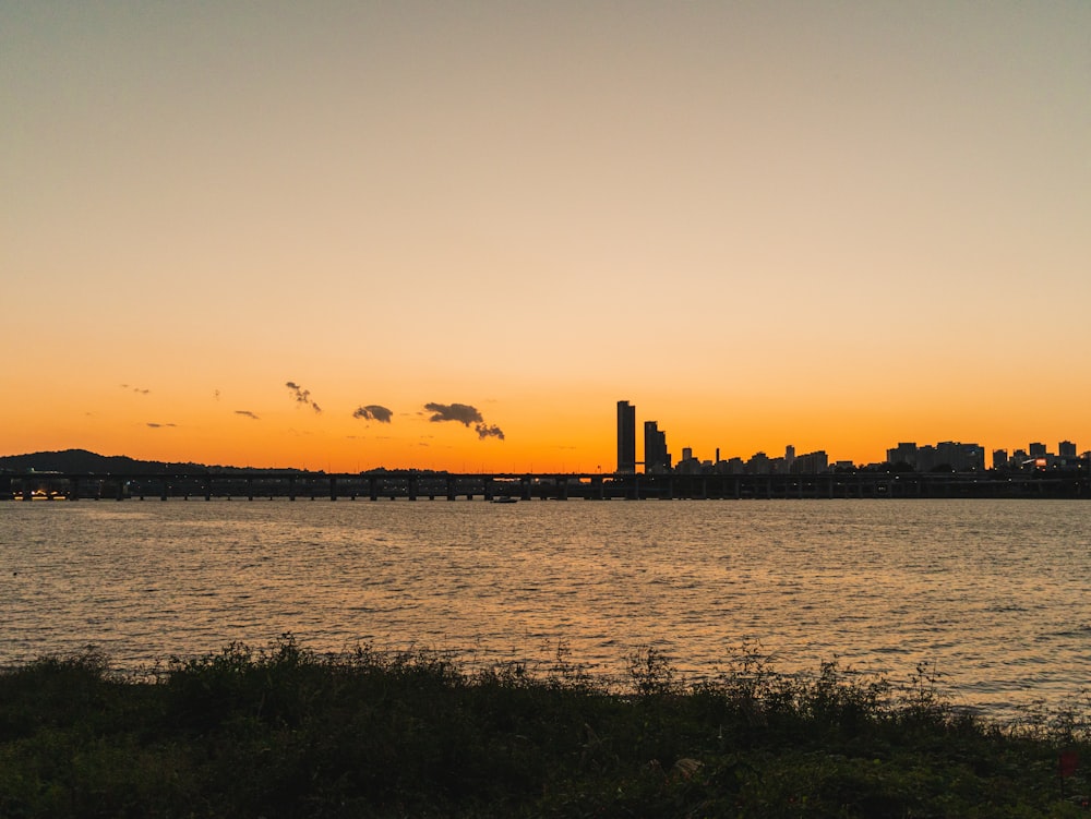 a body of water with a city in the background