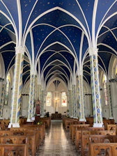 Cozy interior of Horizontas church with soft blue and gold accents during service.
