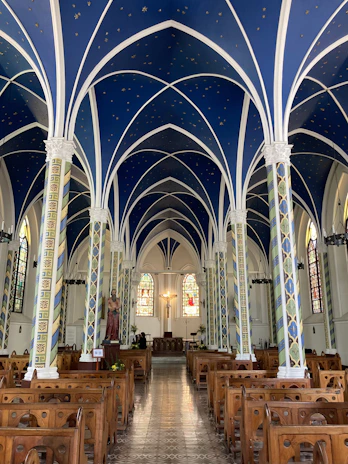 Cozy interior of Horizontas church with soft blue and gold accents during service.