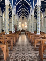 The elegant minimalist interior of the church with blue and gold accents reflecting the night sky.