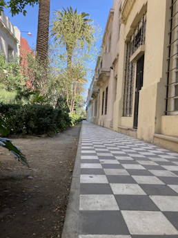 Wide, clean concrete sidewalk running alongside a retail storefront in Panama City.