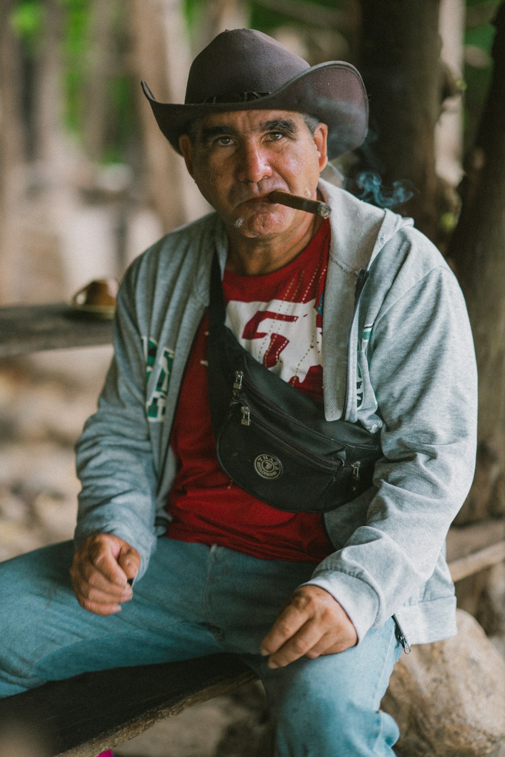 a man in a cowboy hat smoking a cigarette