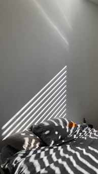 Soft morning light filtering through sheer curtains onto a minimalist vanity with skincare products arranged neatly.