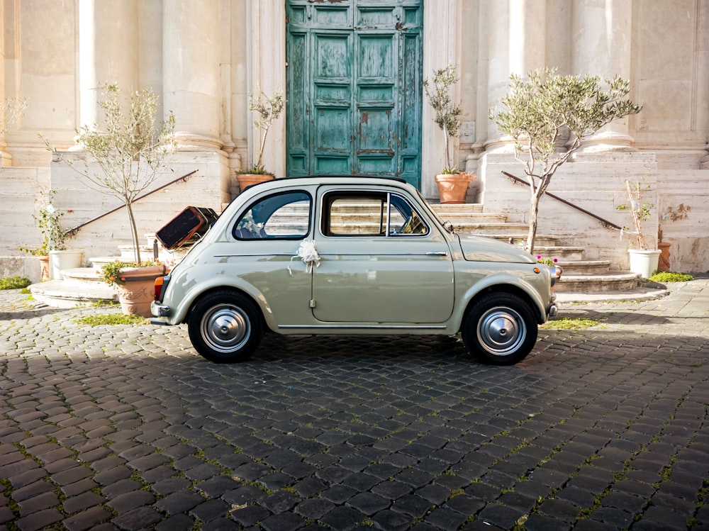 a small car parked in front of a building