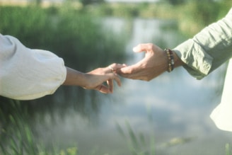 A casual handshake between two people outdoors, symbolizing potential collaboration.