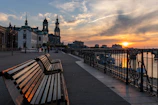 Scenic riverside walk along the Adige River at sunset.