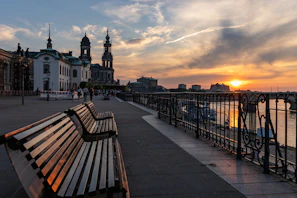 Scenic riverside walk along the Adige River at sunset.