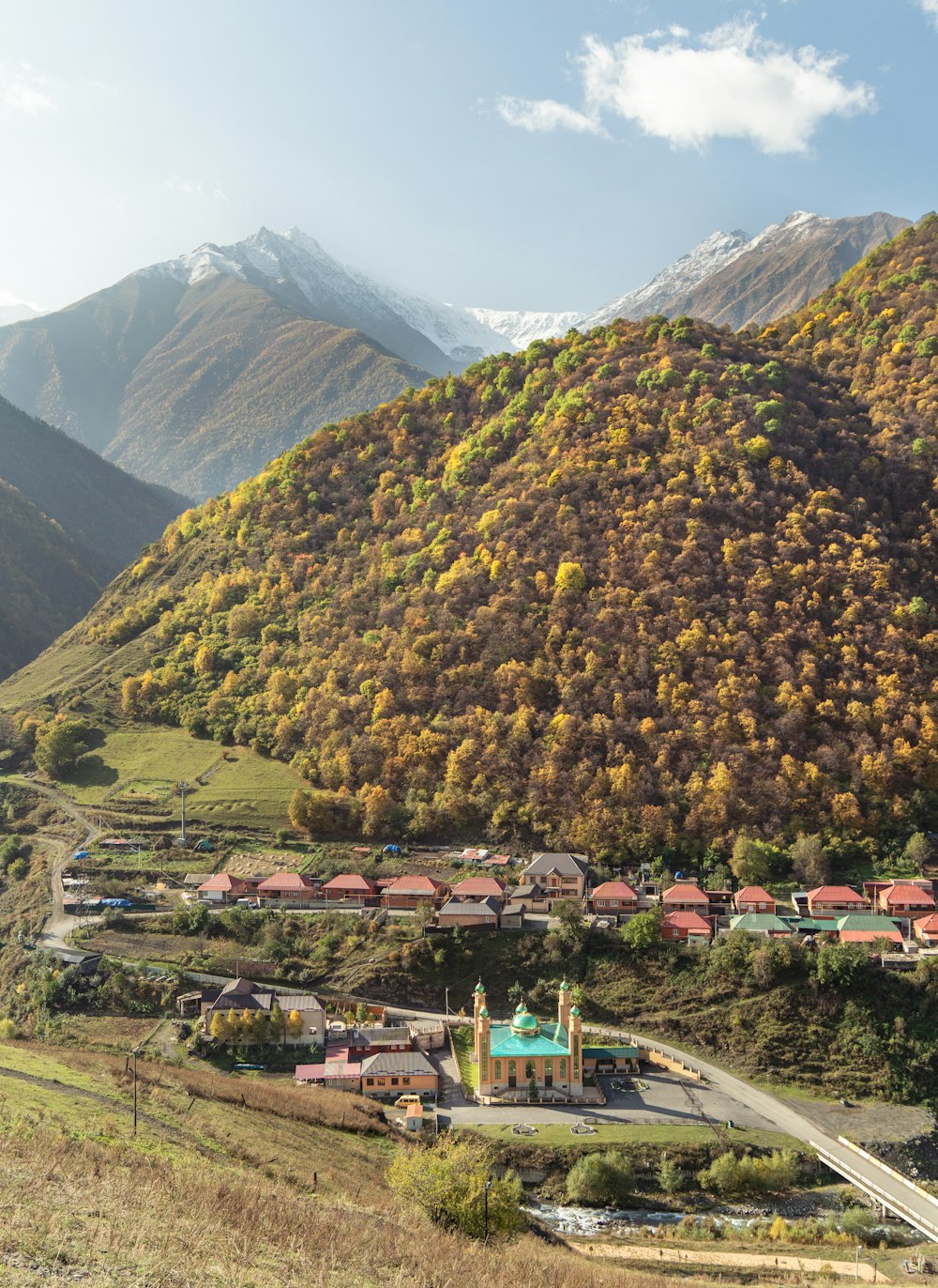 a scenic view of a town in the mountains