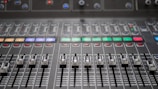 a close up of a sound mixing console