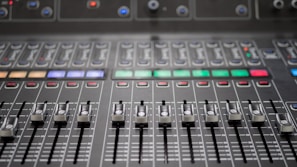 a close up of a sound mixing console