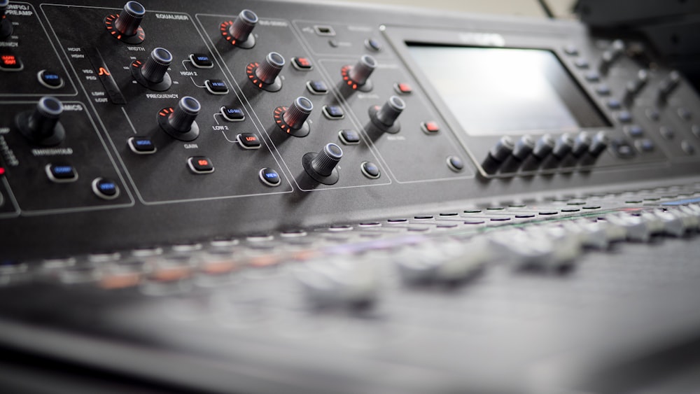 a close up of a sound mixing console