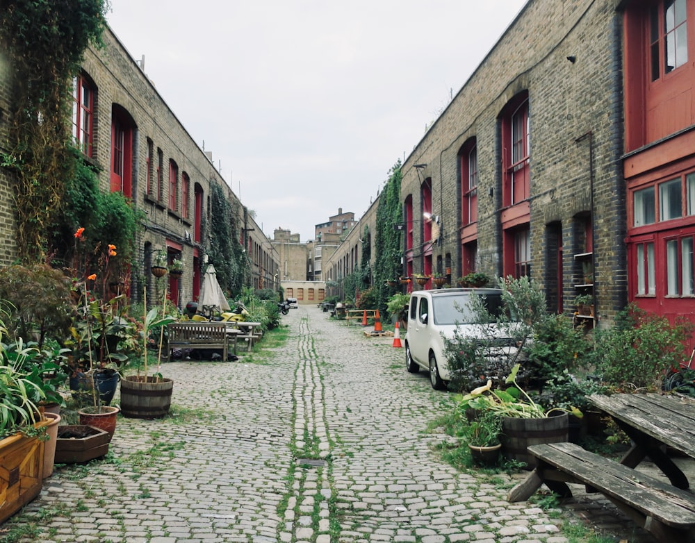 a cobblestone street with a van parked on the side